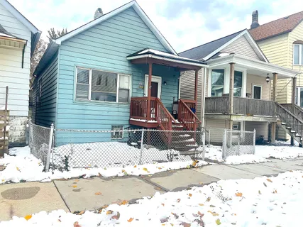 a view of a house with snow on the road