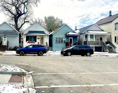 a front view of a house with a garden and parking