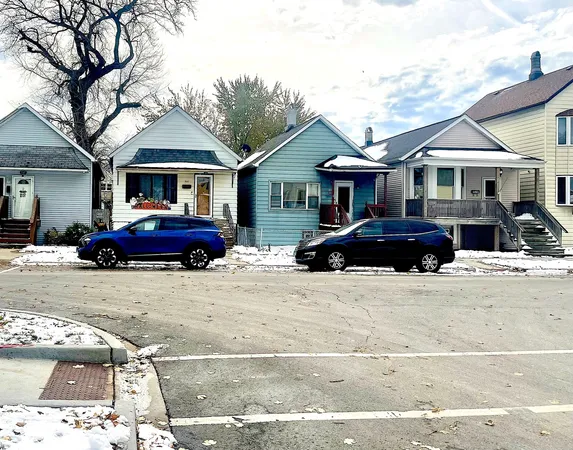 a front view of a house with a garden and parking