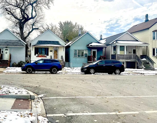 a front view of a house with a garden and parking