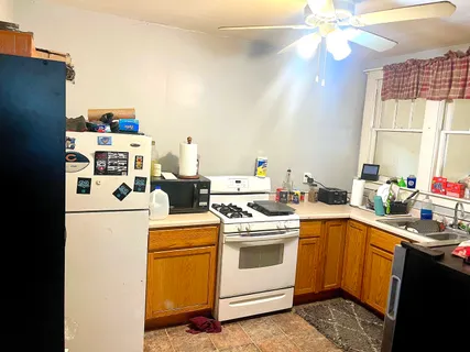 a kitchen with a sink a stove and cabinets