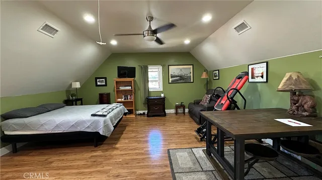 a bedroom with furniture and a wooden floor