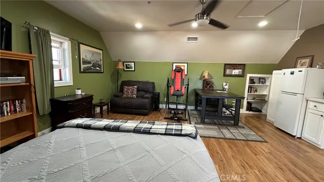 a bedroom with furniture and a wooden floor