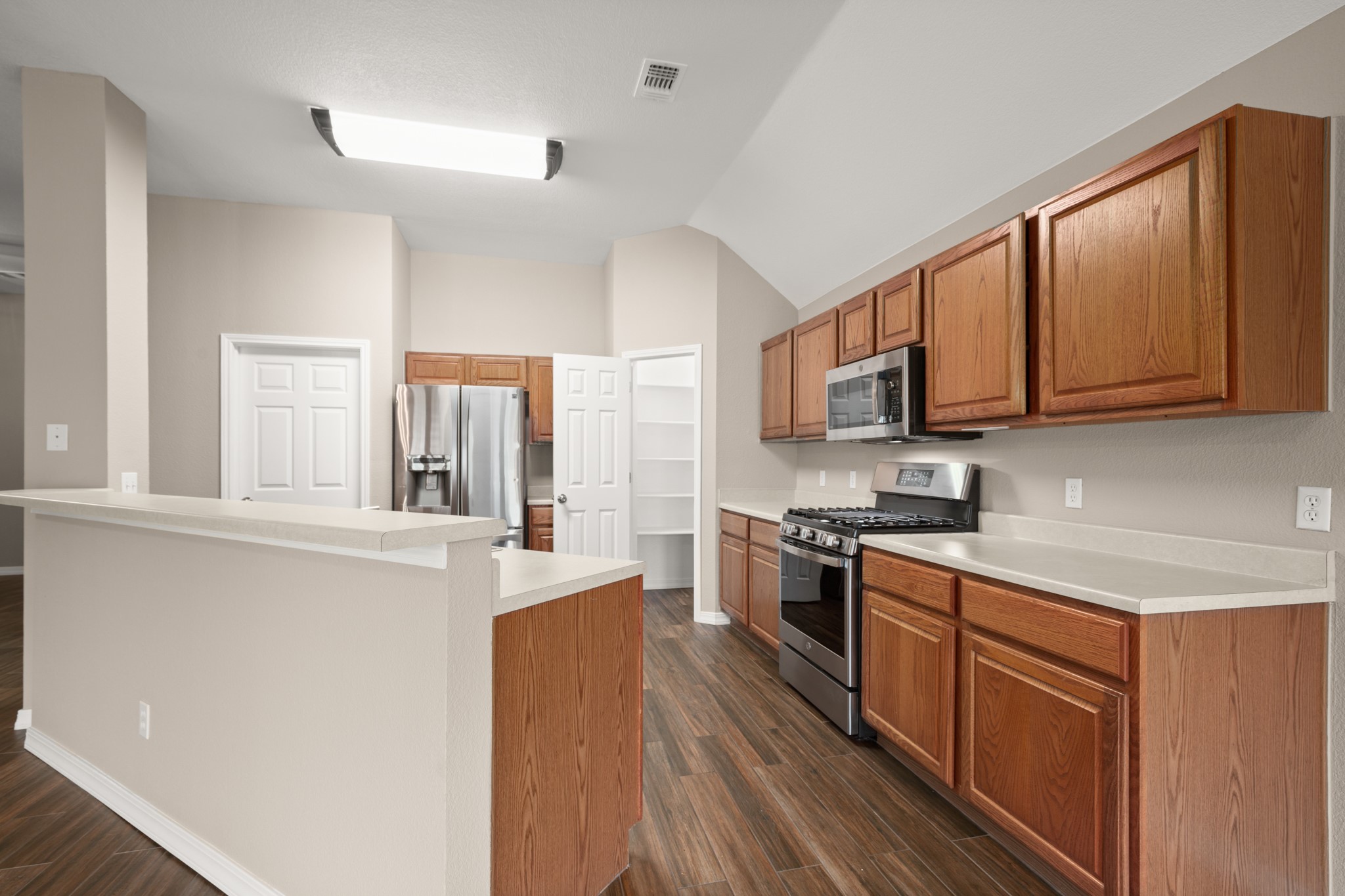 3420 Ribbon Reef Lane Austin, TX 78728 - Photo 6 of 25 Kitchen is open to living spaces and has a corner, walk-in pantry