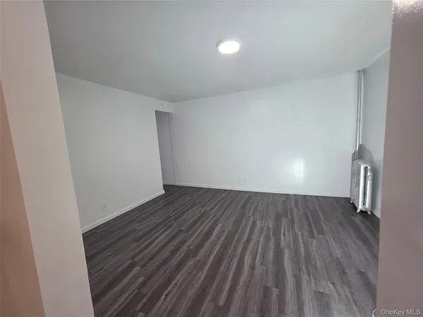 a view of an empty room and wooden floor