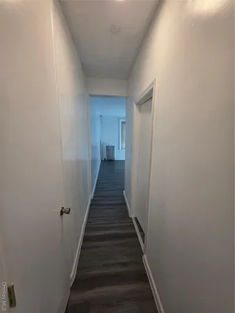 a view of a hallway with the wooden floor