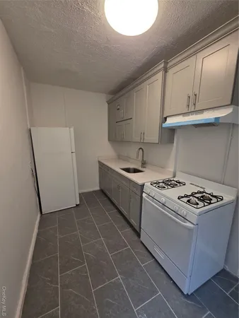 a kitchen with cabinets appliances and a window