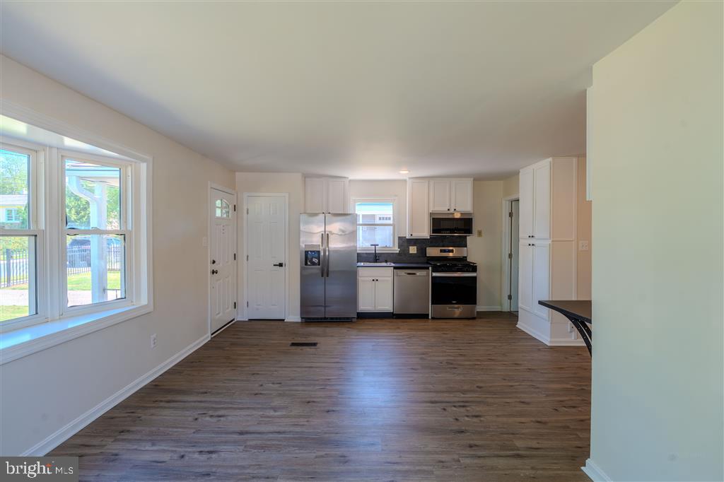 12324 Centerhill Street Silver Spring, MD 20902 - Photo 4 of 24 a kitchen with a refrigerator and a stove top oven