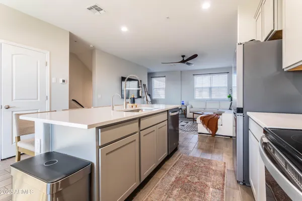 a kitchen with sink refrigerator and stove
