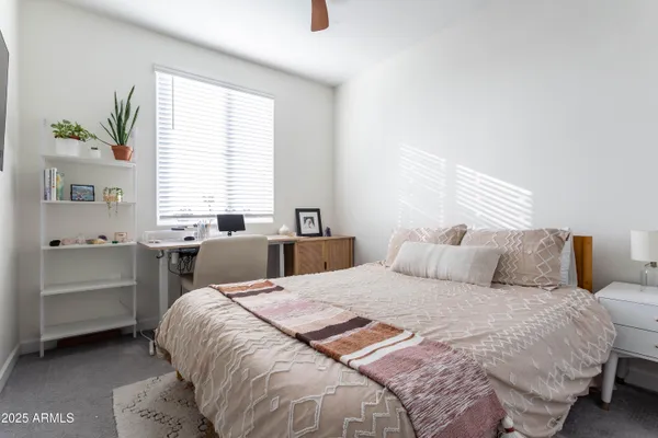 a bed room with a bed and a window