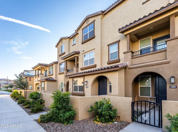 a front view of a residential apartment building with a yard