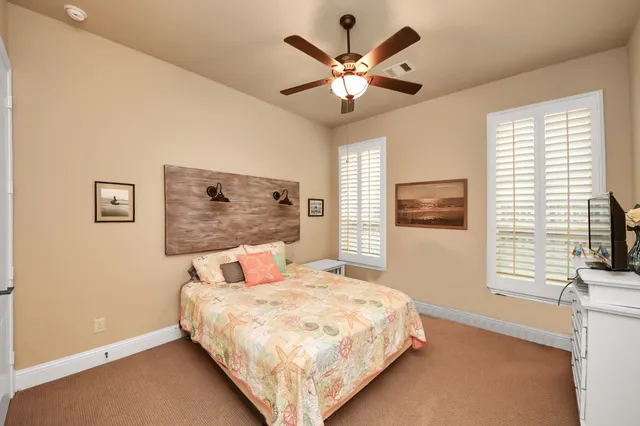 a kitchen with stainless steel appliances granite countertop a stove top oven a sink a dining table and chairs with wooden floor