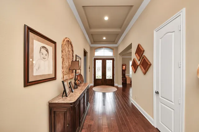 a living room with furniture a flat screen tv and a large window