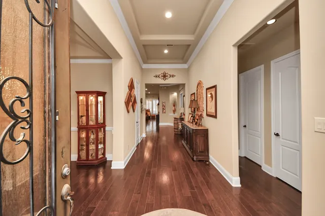 a kitchen with stainless steel appliances a dining table chairs stove and white cabinets