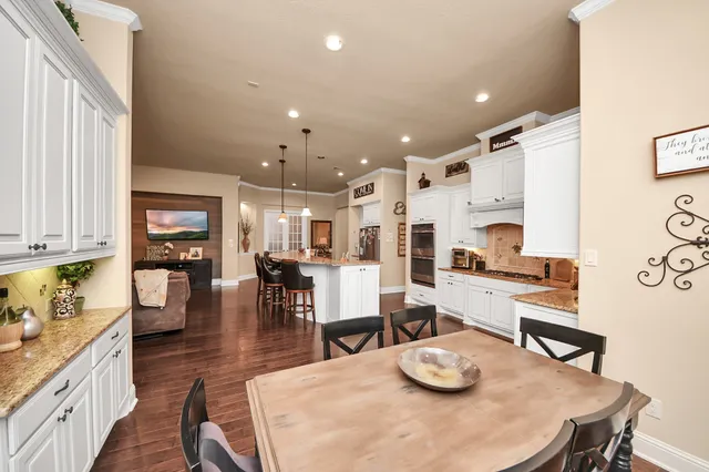 a view of a dining room with furniture and a chandelier