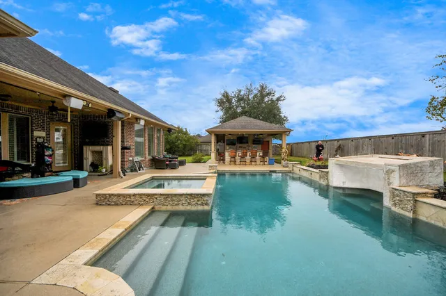 a bathroom with a granite countertop sink mirror vanity and toilet