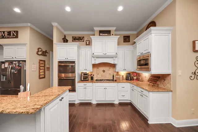 a view of a hallway with wooden floor and stairs