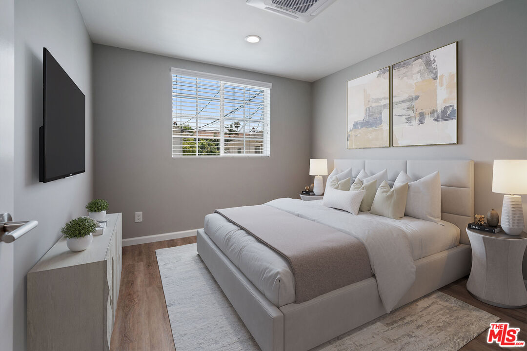 4136 McFarlane Avenue Burbank, CA 91505 - Photo 11 of 24 a bedroom with a large bed and a flat screen tv