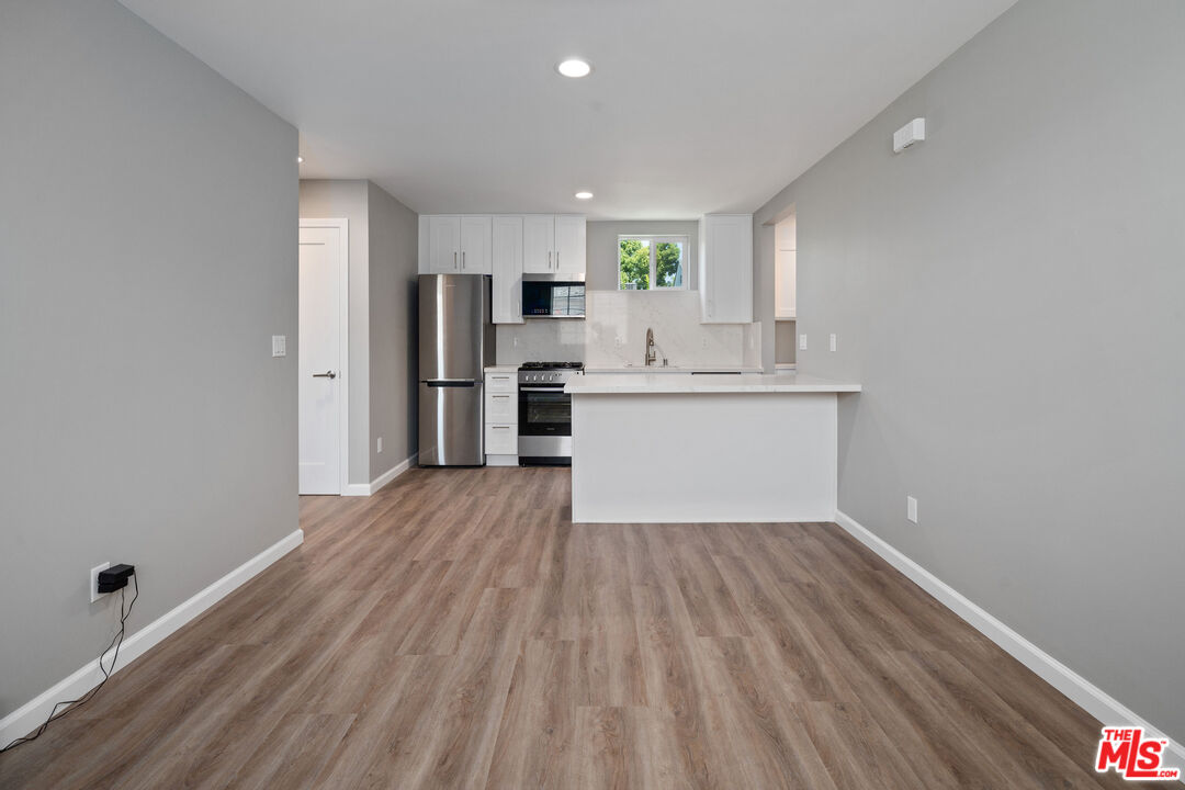 4136 McFarlane Avenue Burbank, CA 91505 - Photo 5 of 24 a kitchen with stainless steel appliances a refrigerator and a stove top oven