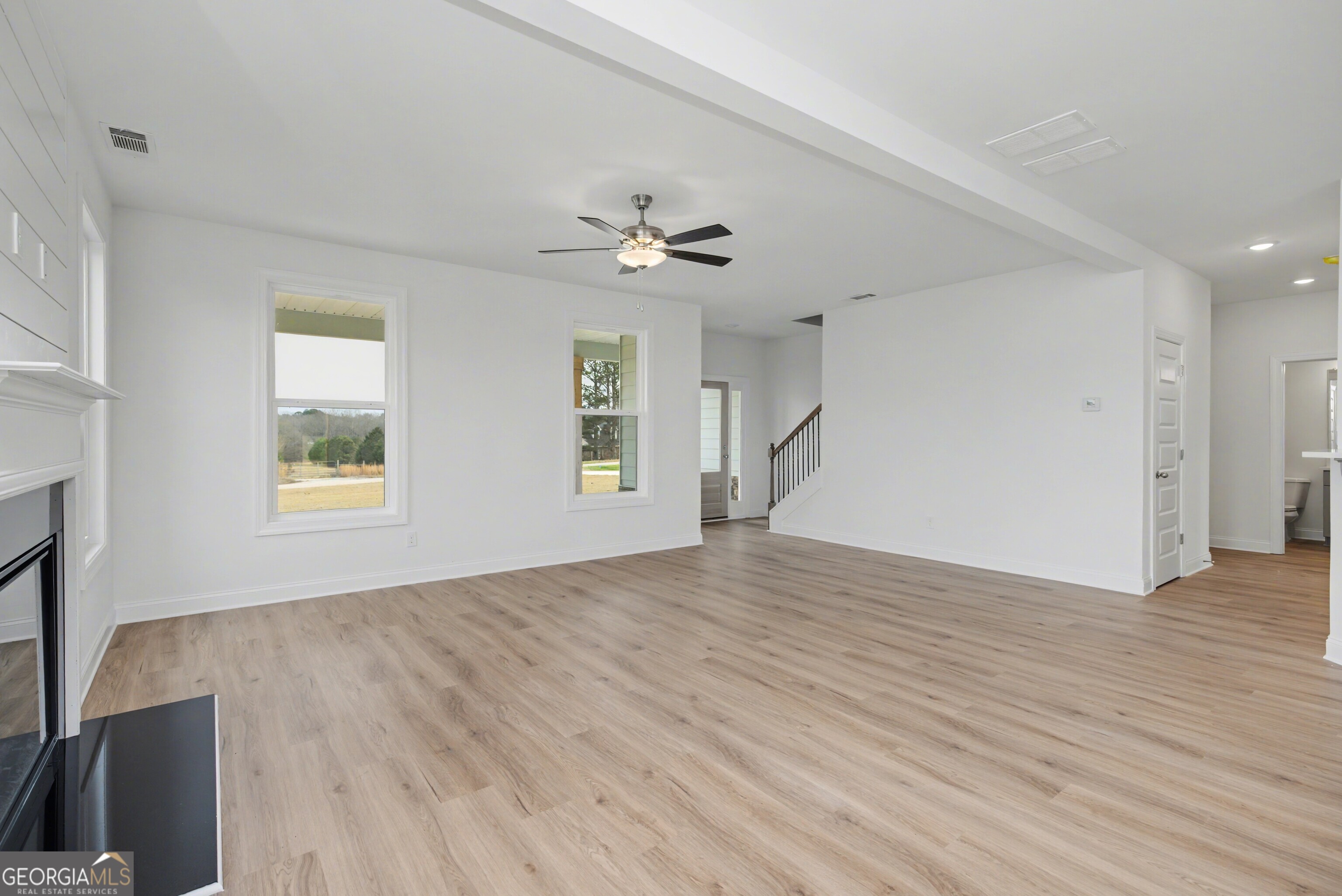 2365 New Hope Road Locust Grove, GA 30248 - Photo 12 of 44 a view of an empty room with a window and wooden floor