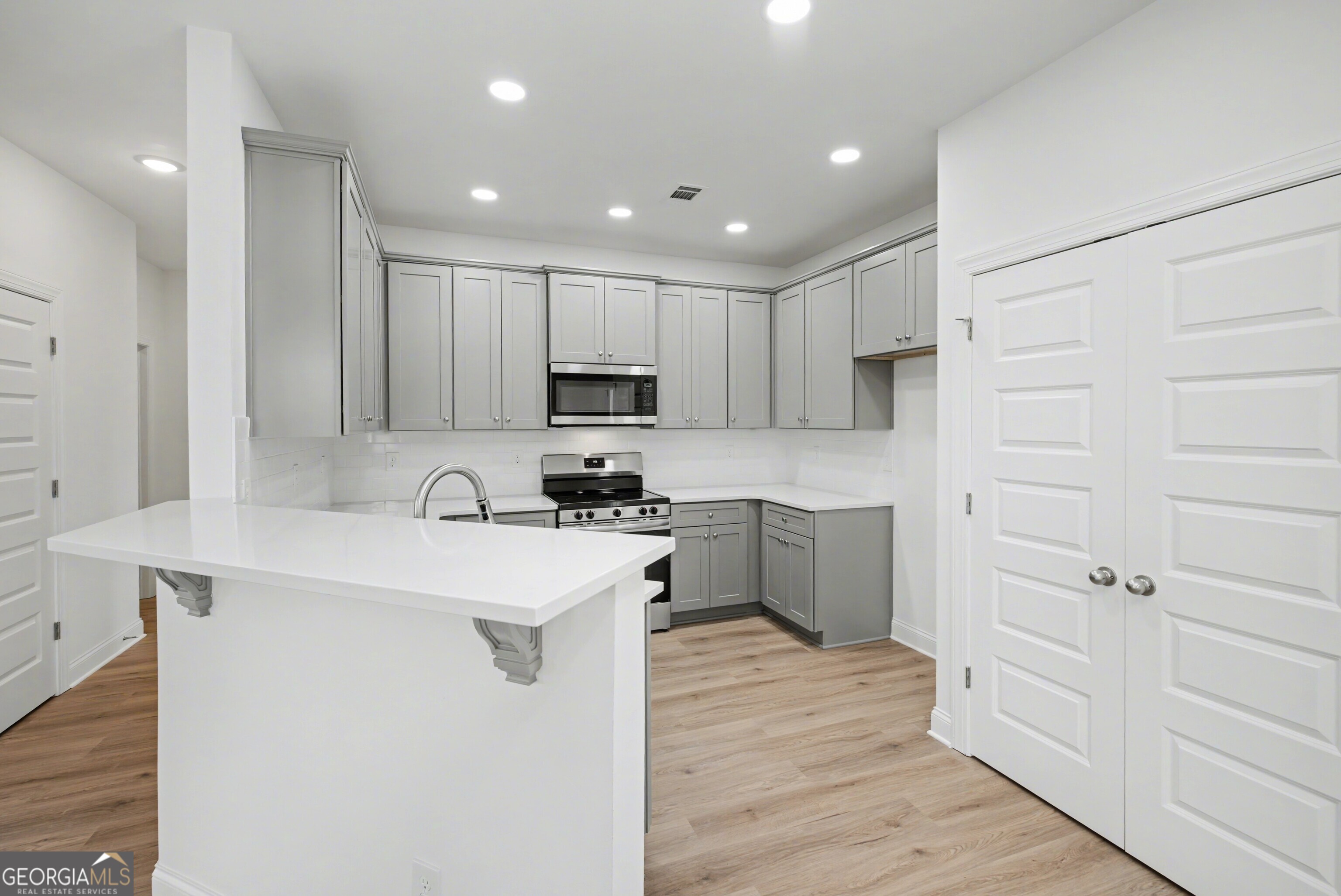 2365 New Hope Road Locust Grove, GA 30248 - Photo 16 of 44 a kitchen with white cabinets appliances and sink