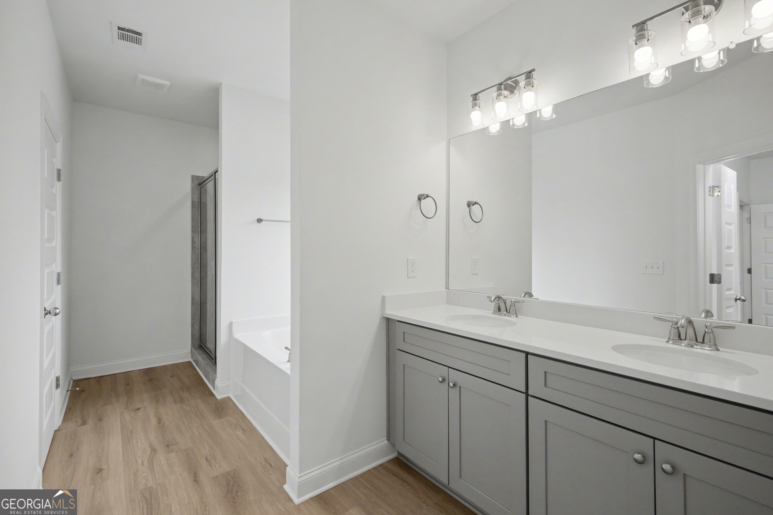 2365 New Hope Road Locust Grove, GA 30248 - Photo 26 of 44 a bathroom with a double vanity sink and a mirror