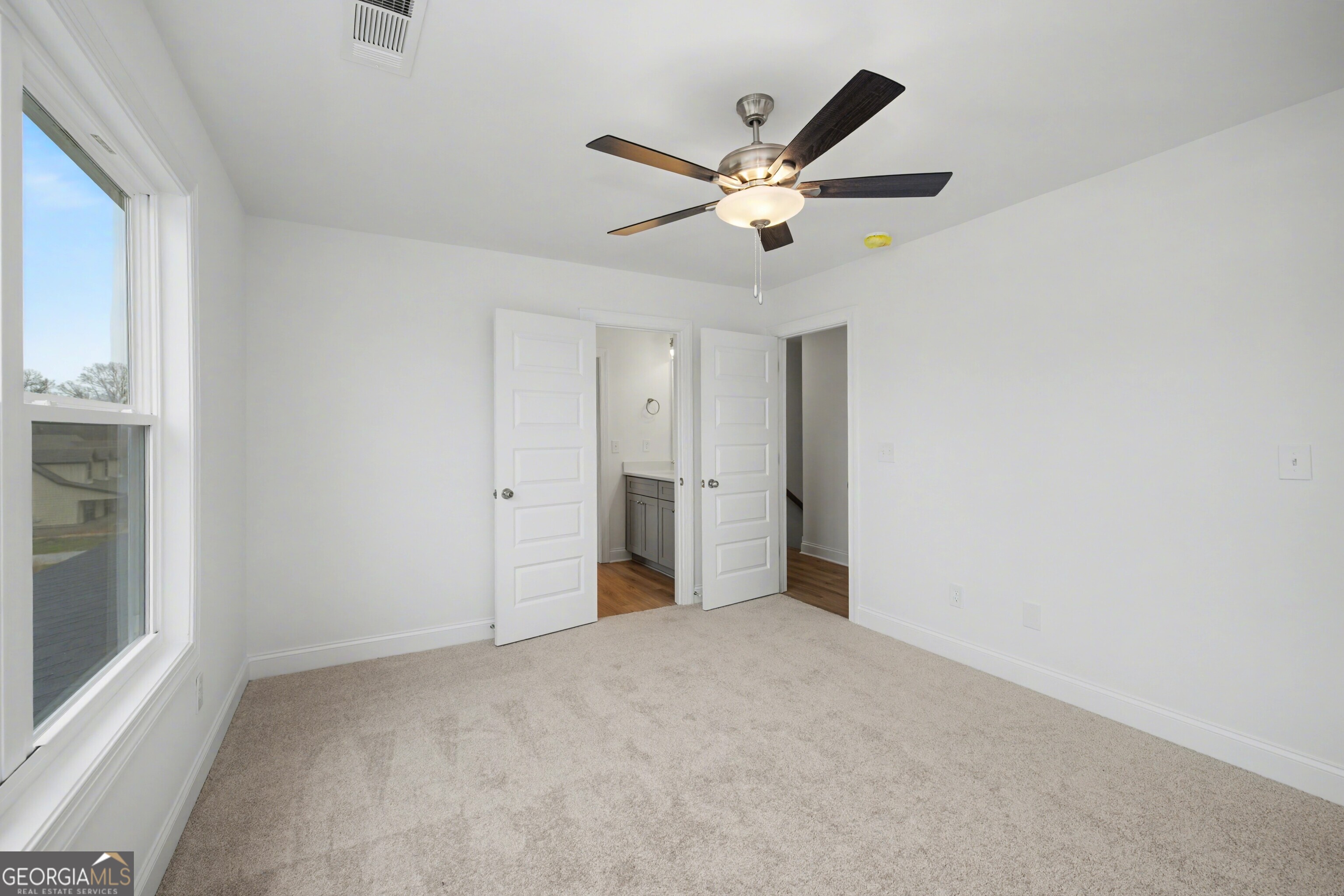 2365 New Hope Road Locust Grove, GA 30248 - Photo 38 of 44 a view of a big room with wooden floor closet and windows