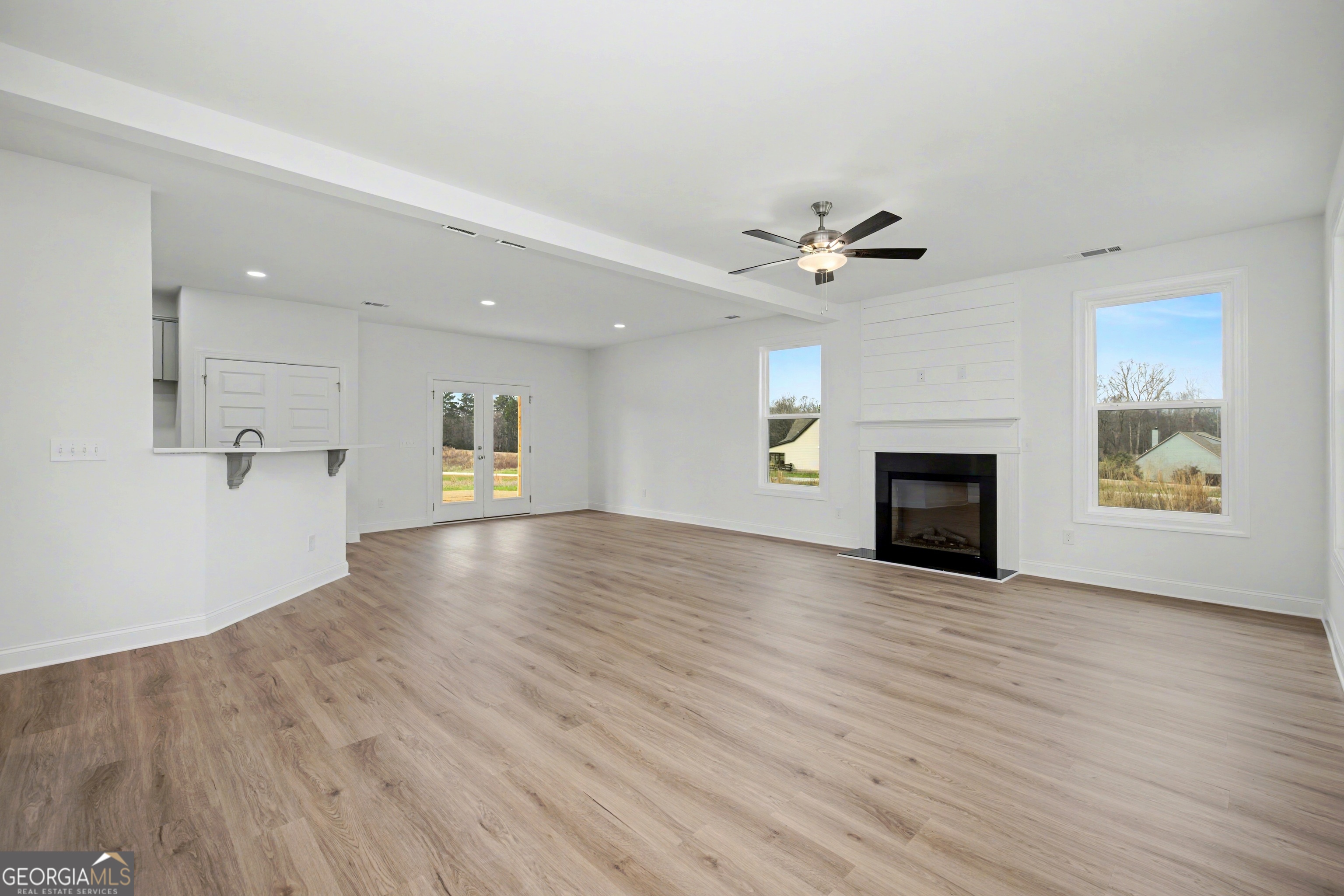 2365 New Hope Road Locust Grove, GA 30248 - Photo 9 of 44 an empty room with fireplace and wooden floor