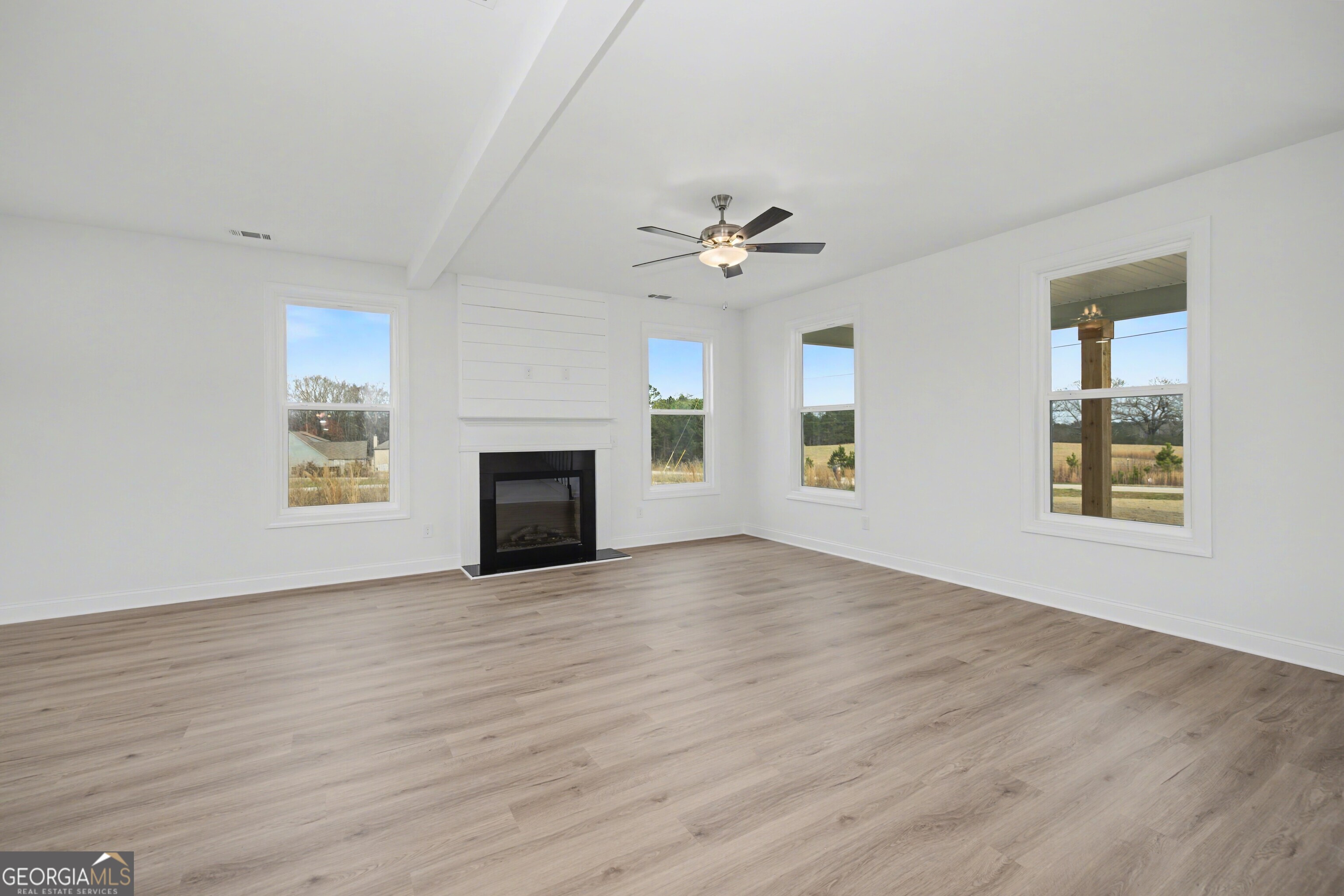 2365 New Hope Road Locust Grove, GA 30248 - Photo 10 of 44 a view of an empty room with a window and fireplace