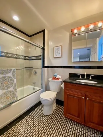 a bathroom with a sink toilet a mirror and shower