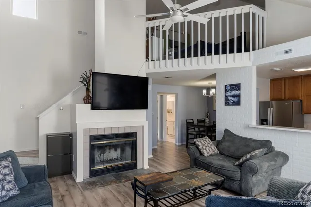 a living room with furniture fireplace and flat screen tv