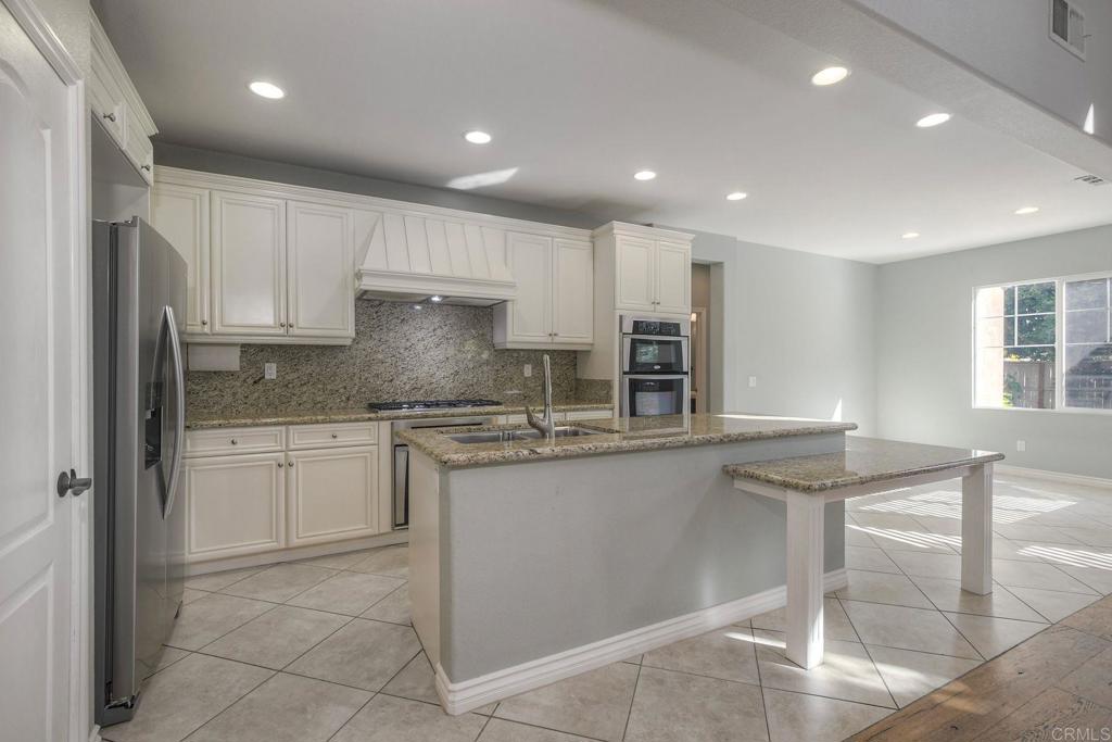 1789 Lemon Tree Court San Marcos, CA 92078 - Photo 9 of 34 a kitchen with stainless steel appliances granite countertop a stove a sink and a refrigerator