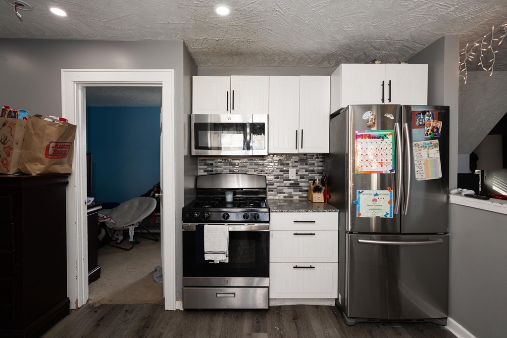 700 Franklin Street Worcester, MA 01604 - Photo 15 of 24 a kitchen with a refrigerator and a stove top oven