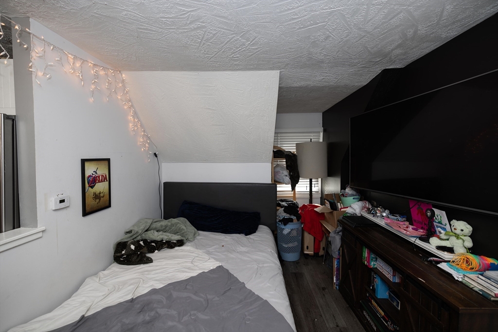 700 Franklin Street Worcester, MA 01604 - Photo 19 of 24 a bedroom with a bed and a tv in it
