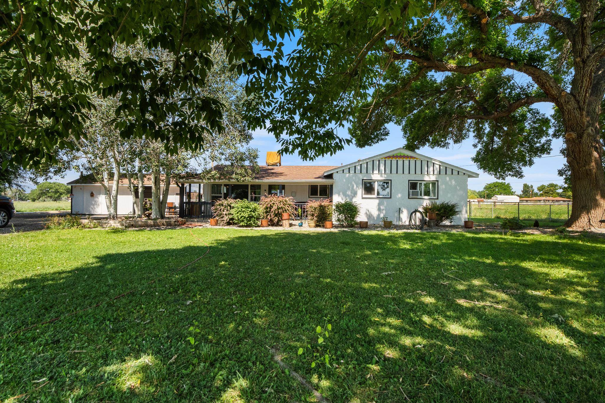 a view of house with a yard