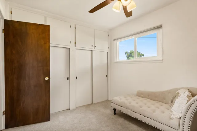 a bedroom with a bed and a painting on the wall