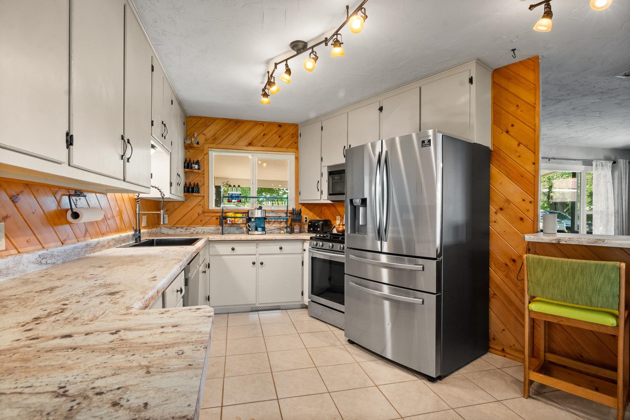 665-30 30 1/2 Road Grand Junction, CO 81504 - Photo 9 of 38 a kitchen with granite countertop a refrigerator and a sink