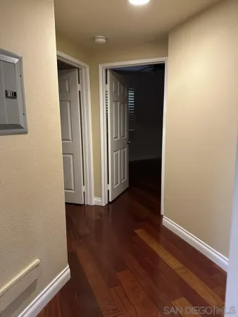 a view of a room with wooden floor and windows