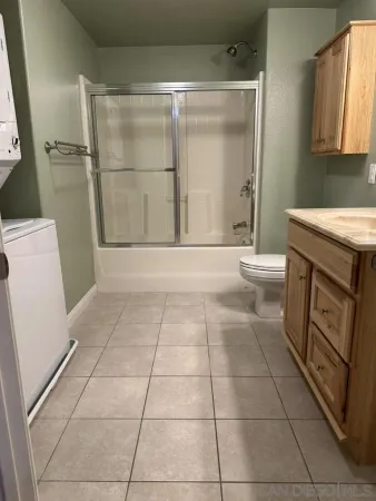 a view of a storage & utility room with dryer and washer