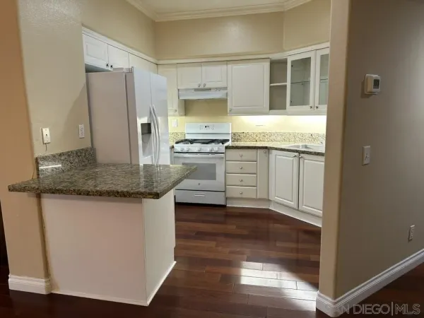 a view of a room with a chair and potted plant