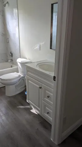 a bathroom with a toilet a sink and mirror