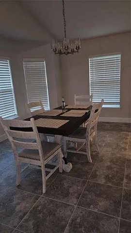 a view of a dining room with furniture and chandelier