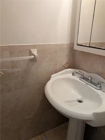 a bathroom with a sink and a window