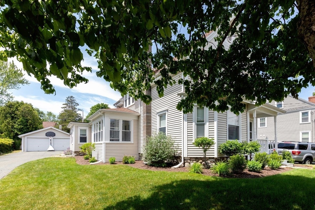 1012 Washington Street Whitman, MA 02382 - Photo 7 of 37 a front view of a house with a yard and trees