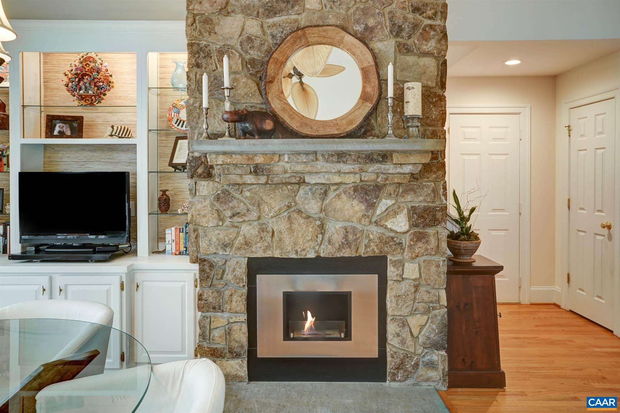 3315 Darby Road Keswick, VA 22947 - Photo 12 of 67 a living room with a fireplace and a flat screen tv