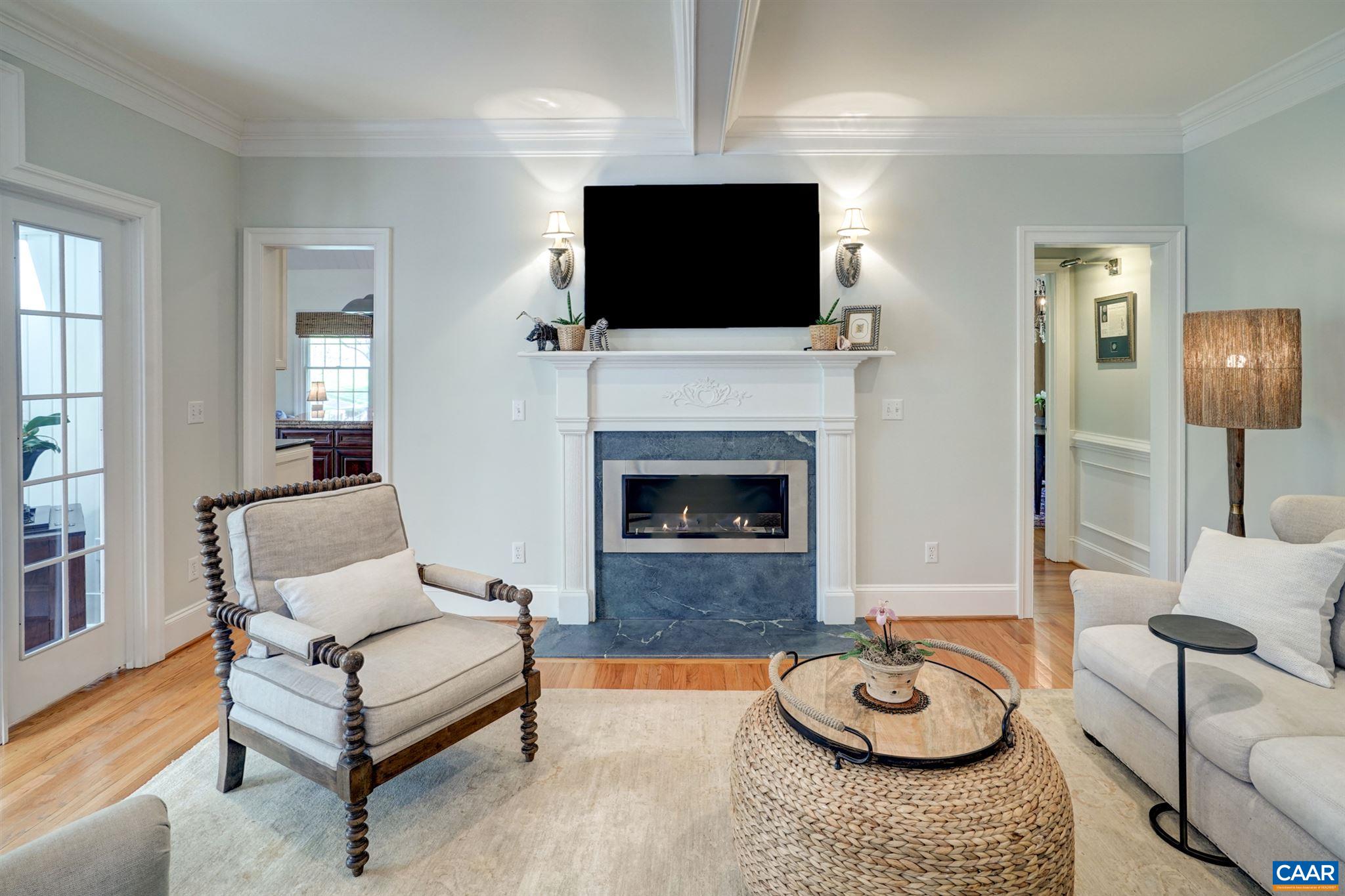 3315 Darby Road Keswick, VA 22947 - Photo 19 of 67 a living room with furniture a flat screen tv and a fireplace