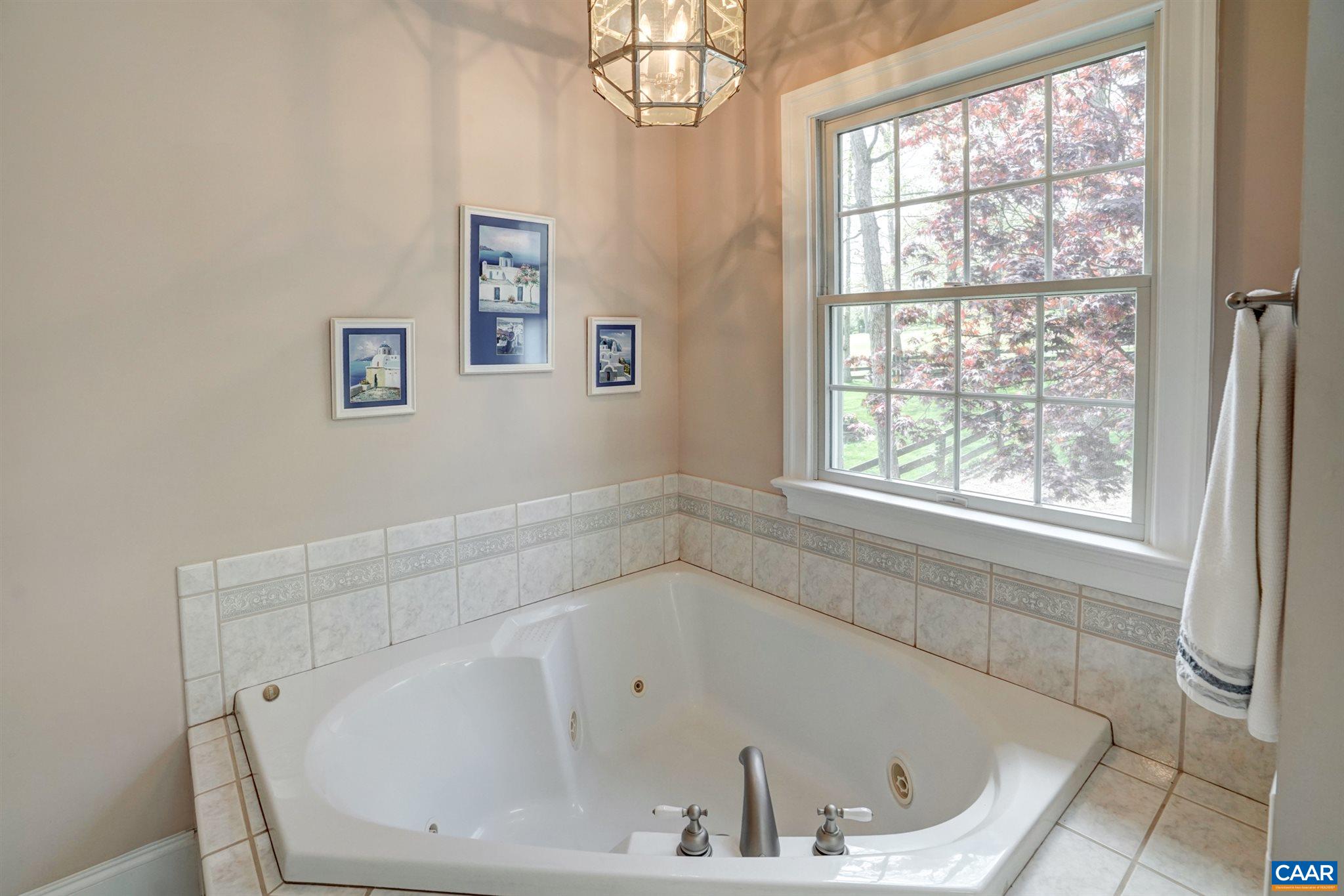 3315 Darby Road Keswick, VA 22947 - Photo 31 of 67 a white bath tub sitting in a bathroom next to a window