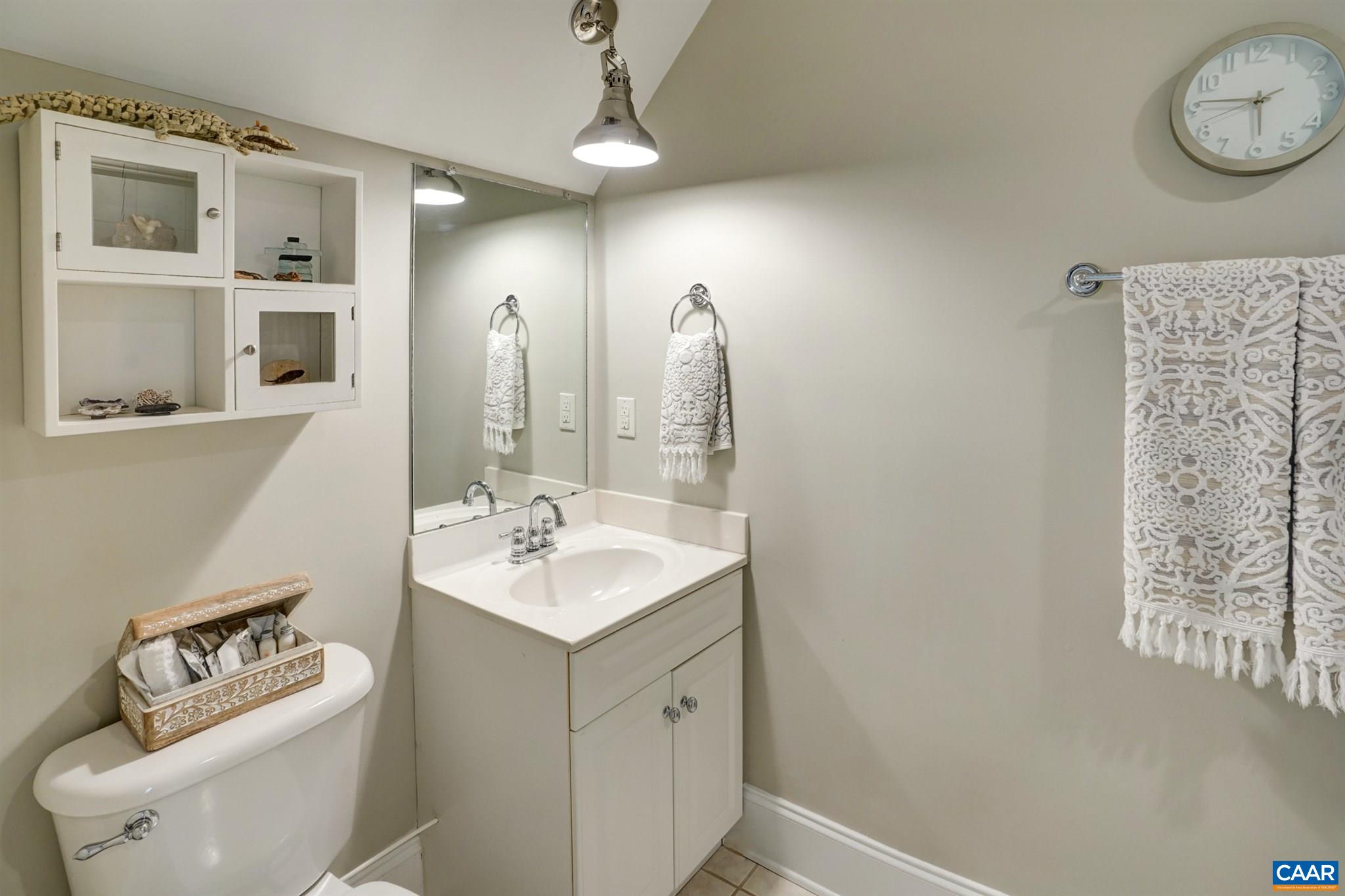 3315 Darby Road Keswick, VA 22947 - Photo 36 of 67 a bathroom with a sink vanity granite toilet and a mirror