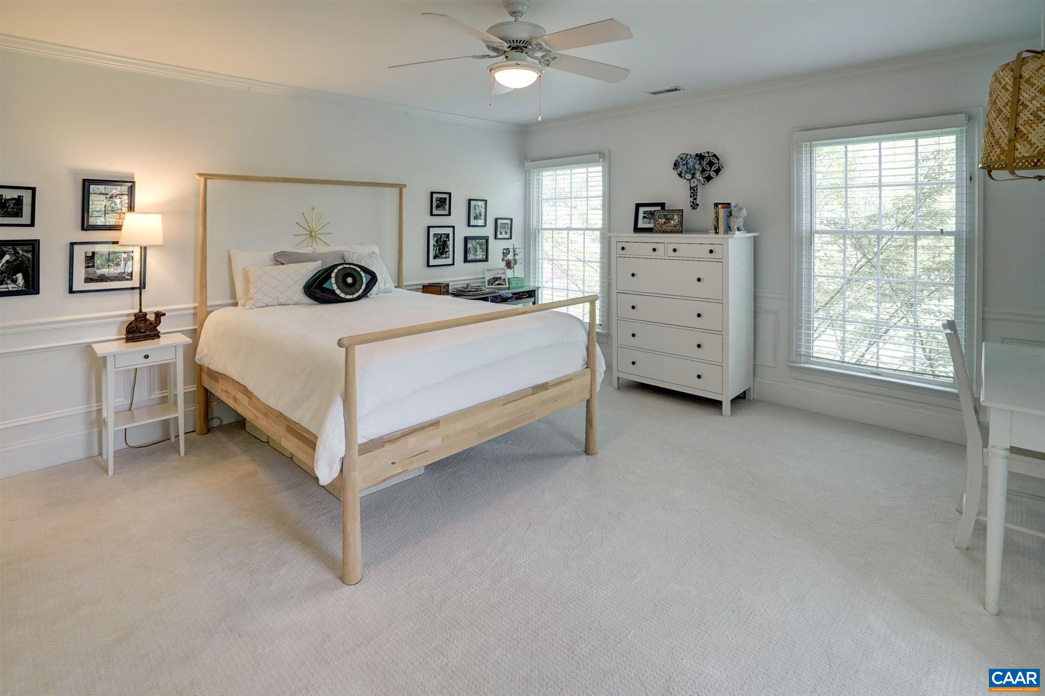 3315 Darby Road Keswick, VA 22947 - Photo 37 of 67 a bedroom with a bed a dresser and a window