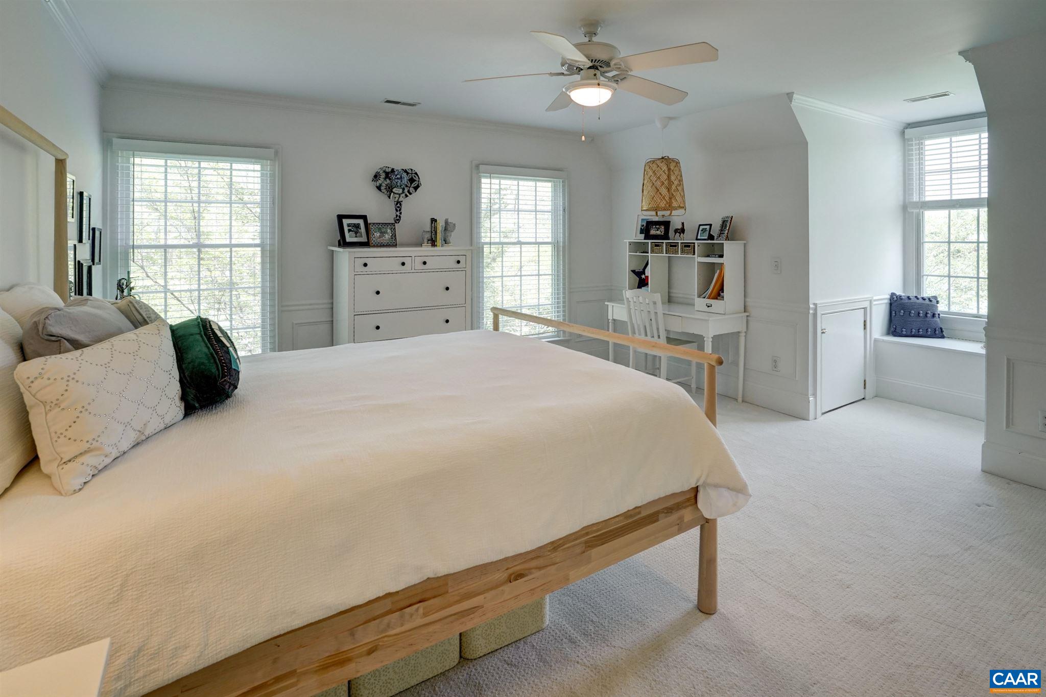 3315 Darby Road Keswick, VA 22947 - Photo 38 of 67 a bedroom with a large bed and a chandelier